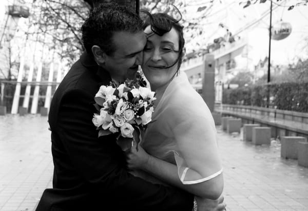 Black and white picture of a bride and groom hugging by Fiona Kelly Photography