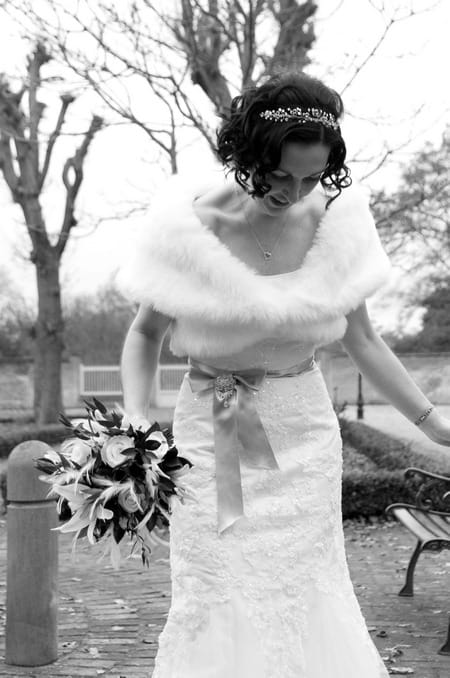 Black and white picture of a bride looking down by Fiona Kelly Photography