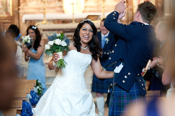 Picture of a bride laughing with her groom by Fiona Kelly Photography