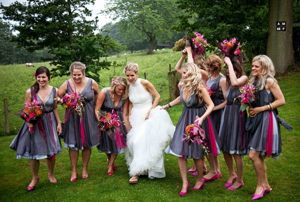 Picture of a bride and her bridesmaids walking across a field by Anneli Marinovich Photography