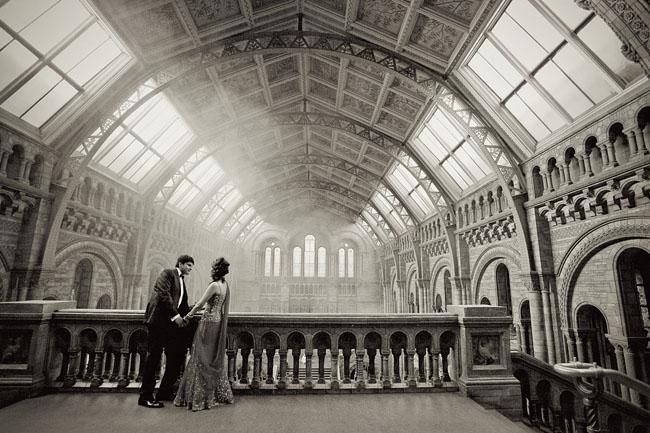 Black and white picture of bride and groom inside the Natural History Museum