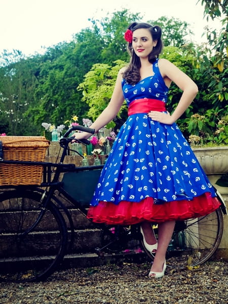 Vintage bride standing with bicycle - Vintage Wedding Shoot