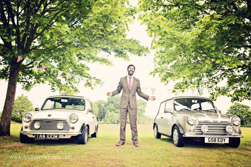 Groom standing by Mini wedding cars by Andrew J R Squires Photography