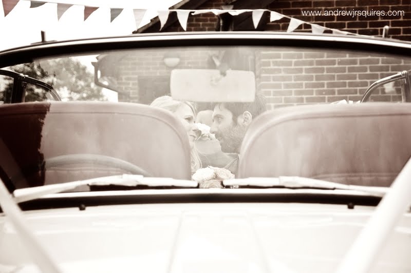 Bride and groom in the back of a car by Andrew J R Squires Photography