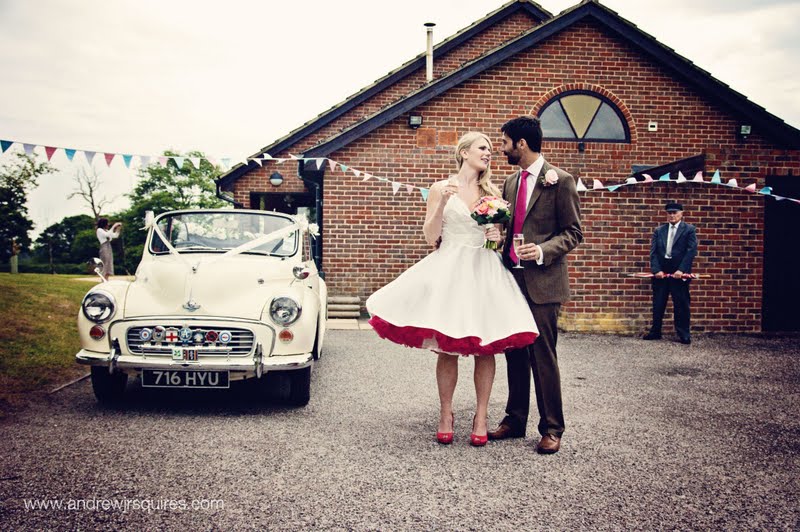Couple standing by a wedding car by Andrew J R Squires Photography
