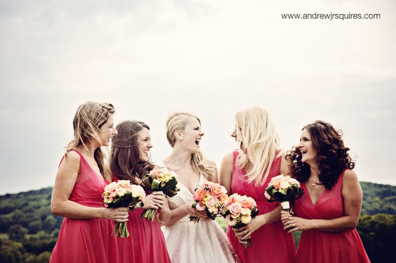 A bride laughing with her bridesmaids by Andrew J R Squires Photography