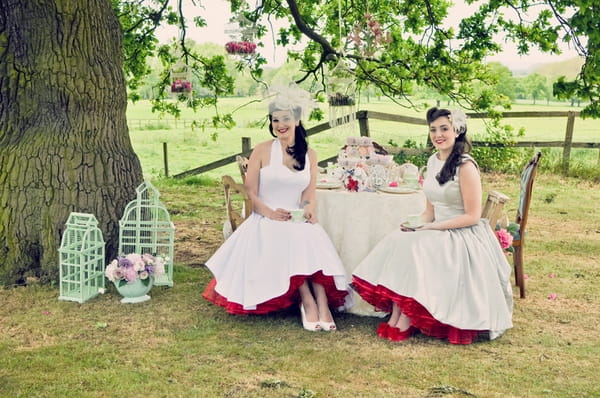 Vintage brides sat at a table - Vintage Wedding Shoot