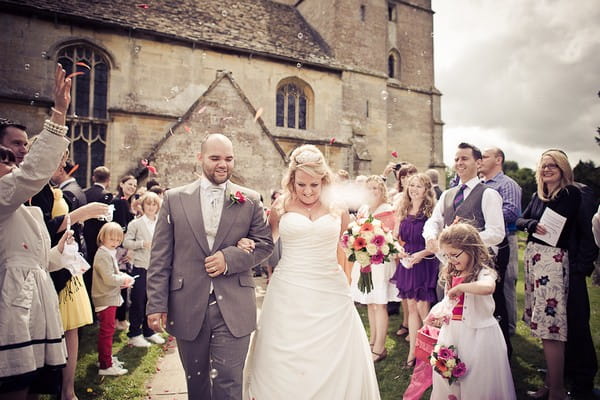 Bride and groom having confetti thrown over them - Martins Kikulis Photography