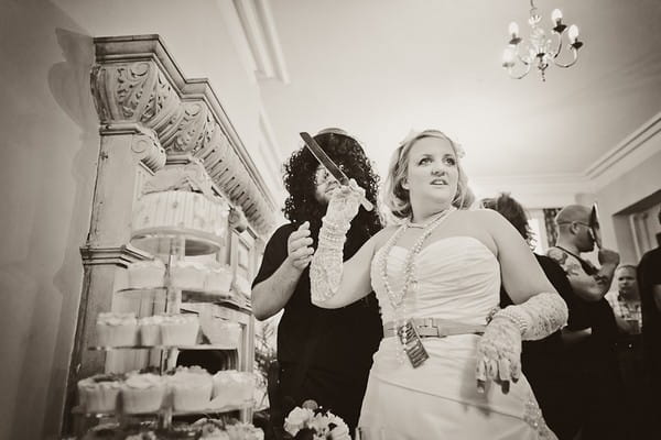 Bride and groom cutting wedding cake - Martins Kikulis Photography