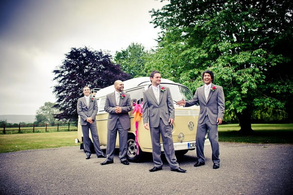 Groomsmen standing by a VW Camper Van