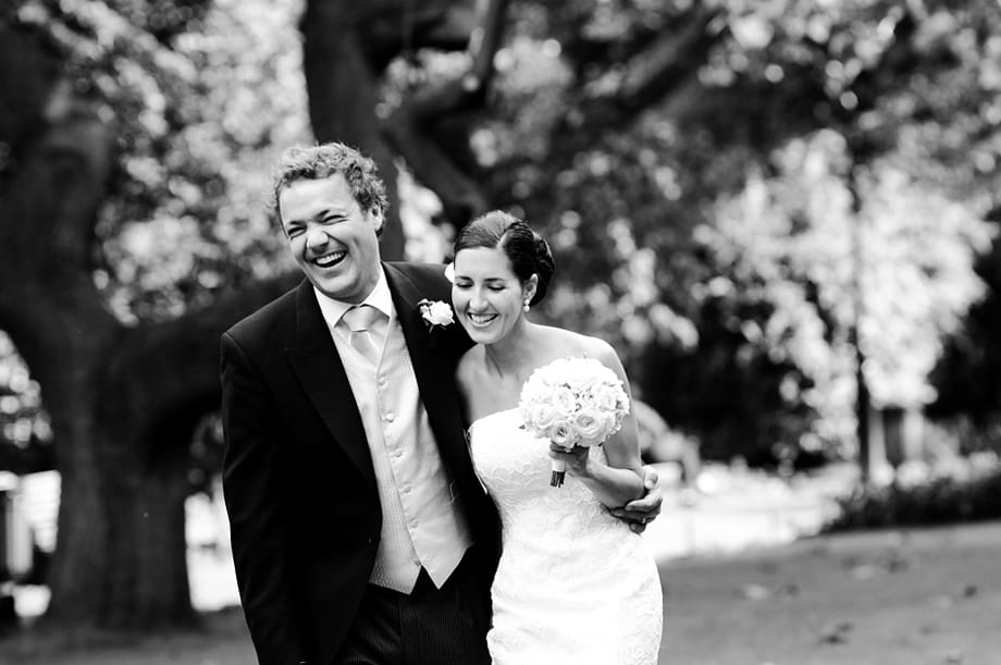 Bride and groom laughing together by Martin Beddall Photography