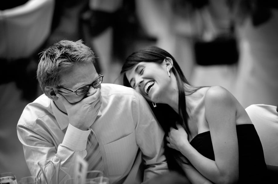 Wedding guests laughing by Martin Beddall Photography