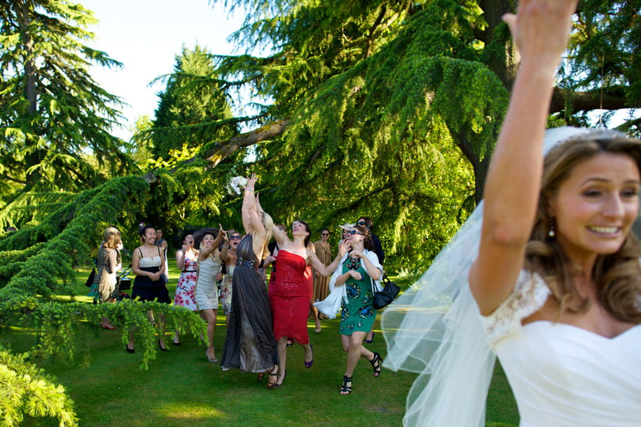 Bride throwing her bouquet by Martin Beddall Photography