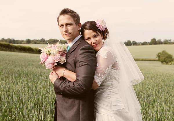 Bride resting her head on her husband's back - Picture by Rebecca Wedding Photography