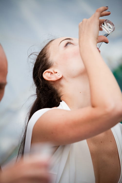 Bride drinking a shot of vodka - Sam Gibson Wedding Photography