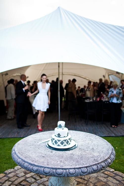 Bride and groom preparing to cut the wedding cake - Sam Gibson Wedding Photography