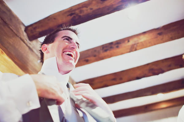 Groom doing up his tie