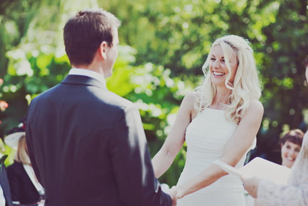 Bride and groom holding hands at the altar