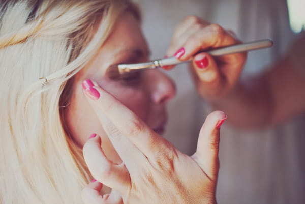 Bride having eyeshadow applied