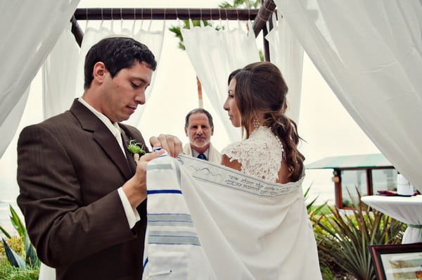 Groom placing Chuppah around bride - Picture by Captured by Aimee