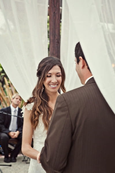 Bride smiling during wedding ceremony - Picture by Captured by Aimee