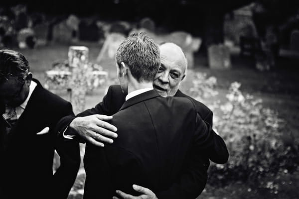 Groom hugging man - Picture by Andrew J R Squires Photography