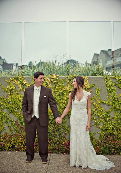 Bride and groom standing holding hands - Picture by Captured by Aimee