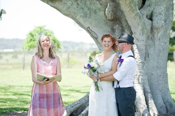 Bride and groom laughing with registrar - Picture by Andrea Sproxton Photography