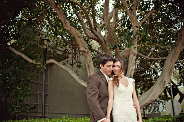 Bride and groom standing in front of a tree - Picture by Captured by Aimee