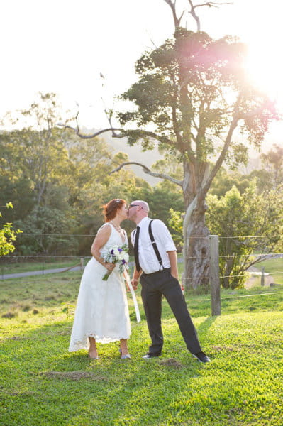 Groom leaning over to kiss his bride - Picture by Andrea Sproxton Photography