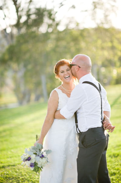 Groom kissing bride on the cheek - Picture by Andrea Sproxton Photography