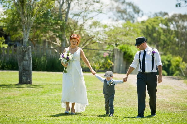 Bride and groom walking with page boy - Picture by Andrea Sproxton Photography