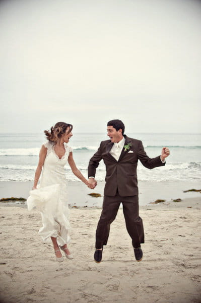 Bride and groom jumping on beach - Picture by Captured by Aimee