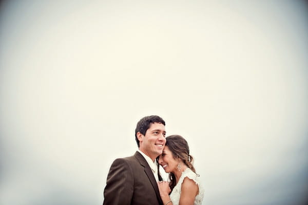 Bride leaning on groom's shoulder - Picture by Captured by Aimee