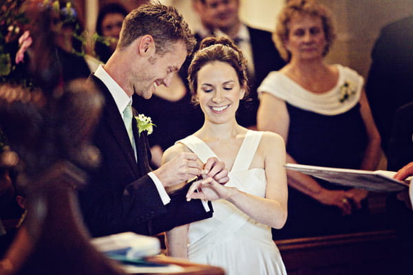 Groom placing ring on bride's finger - Picture by Andrew J R Squires Photography