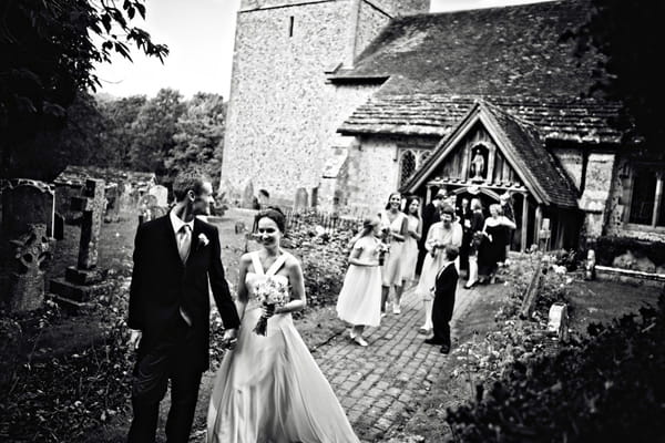 Bride, groom and wedding guests outside of church - Picture by Andrew J R Squires Photography