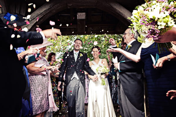 Bride and groom being showered in confetti - Picture by Andrew J R Squires Photography