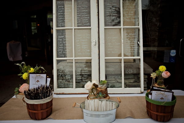 Wedding seating plan written on windows - Picture by Captured by Aimee