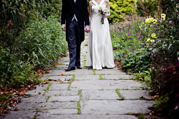 Bride and groom walking along path - Picture by Andrew J R Squires Photography