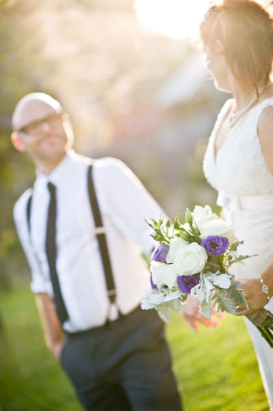 Bride and groom standing in hazy sunshine - Picture by Andrea Sproxton Photography