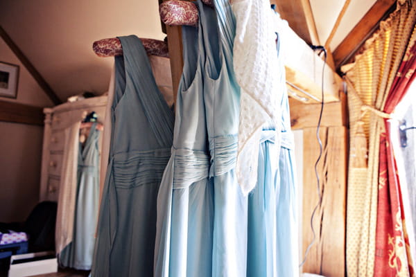 Light blue bridesmaid dresses hanging up - Picture by Andrew J R Squires Photography