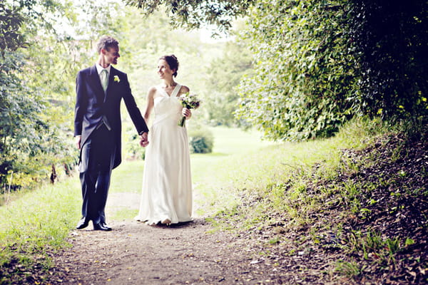 Bride and groom walking hand in hand - Picture by Andrew J R Squires Photography