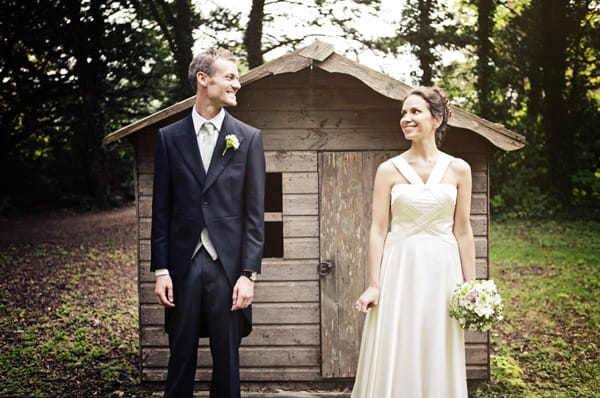 Bride and groom standing infront of shed - Picture by Andrew J R Squires Photography