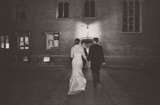 Bride and groom walking into Magdalene College