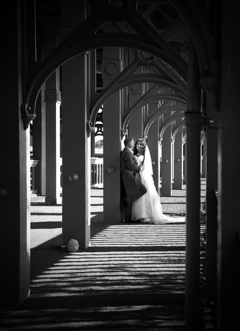 Bride and groom under arches - Picture by Jamie Penfold Photography