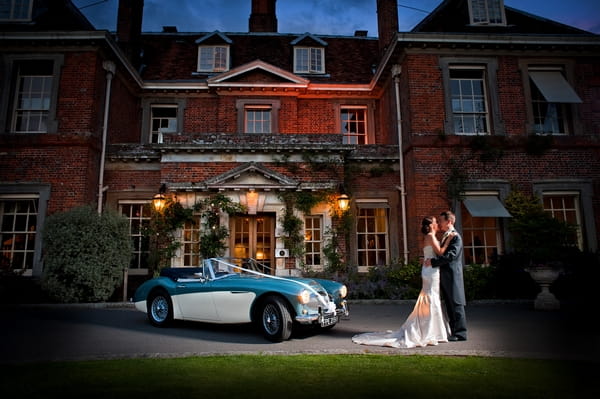 Bride, groom and vintage car outside wedding venue - Picture by Lemontree Photography