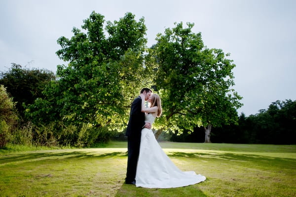 Bride and groom kissing in front of a tree - Picture by Lemontree Photography