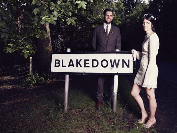 Bride and groom standing by Blakedown sign - Picture by Ian Shoots Weddings