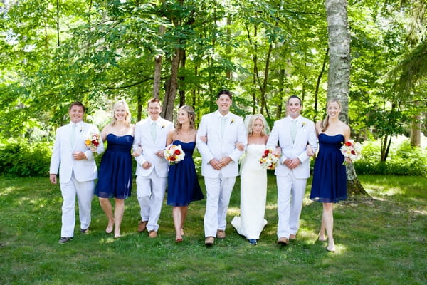 Bridal party walking arm in arm - Picture by Laura Ivanova Photography