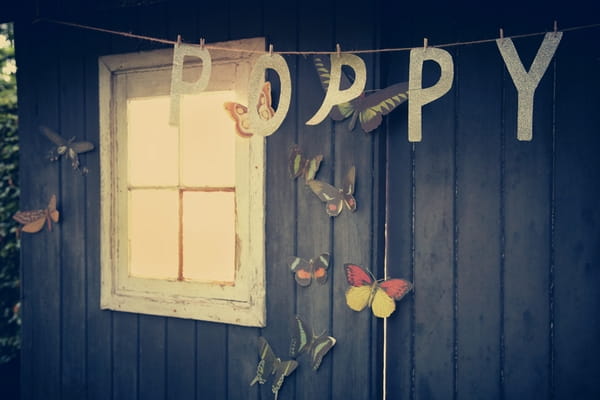 Poppy letters hanging in front of shed - Picture by Ian Shoots Weddings